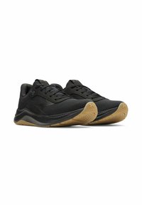 Black athletic shoes with a breathable upper, lace-up closure, and textured gum rubber outsole featuring a zigzag pattern for grip.