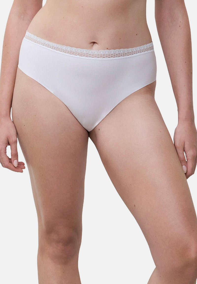 Woman wearing white high-cut lace waistband underwear, shown from waist to mid-thigh against a plain background.