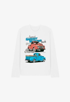 Weißes Langarmhemd mit Illustrationen von roten und blauen Vintage-Ford-Pickup-Trucks und dem Text "Amerikas härtester Arbeitstier Ford."