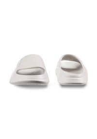 Light gray slide sandals with an open design, smooth plastic surface, textured footbed, and cut-out details on the side.