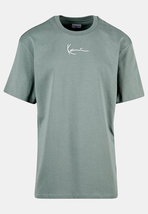 Green cotton t-shirt with short sleeves, a crew neck, and white cursive text on the chest. Smooth texture, classic fit.