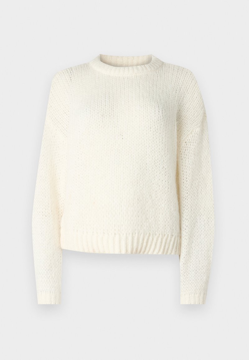 Pull léger en tricot crème, avec des manches longues, un col rond et un ourlet côtelé. Tissu texturé avec une coupe ample et décontractée.