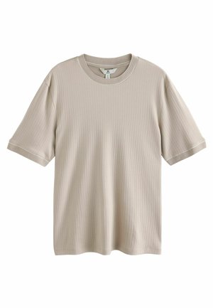 T-shirt color beige chiaro realizzata in tessuto a coste, con scollatura rotonda e maniche corte, arricchita da un sottile accento ai polsini.