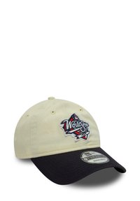 Adjustable baseball cap featuring a cream front, navy brim, and embroidered "World Series" logo in red, blue, and white.