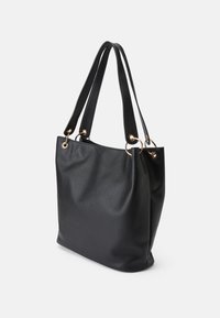 Black leather tote bag with a textured finish, two long handles, and gold-tone hardware accents. Spacious design for everyday use.