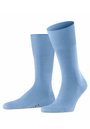 Calzini azzurri chiari con polsini a coste e una texture liscia. Presentano una punta e un tallone rinforzati. Logo stampato alla base.