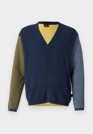 Cardigan tricotat cu un corp bleumarin, material rayat în galben și verde pe o mânecă și o mânecă rayată albastră. Prezintă un decolteu în V și buzunare frontale.