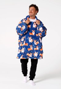 Oversized fleece blanket hoodie featuring a blue background with an all-over corgi print. Soft texture, large hood, and kangaroo pocket.