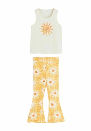 Sleeveless white top with yellow sun graphic paired with yellow flared pants featuring white and orange sun patterns.