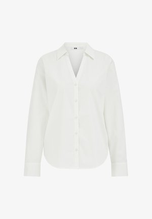 Cămașă albă cu mânecă lungă, decolteu în V și închidere frontală cu nasturi. Prezintă o textură netedă și un tiv curbat. Fabricată dintr-un material ușor.