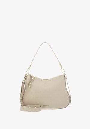 Borsa a mano in pelle beige con cerniera dorata, tracolla staccabile e manico corto, progettata per l'uso quotidiano e la versatilità.