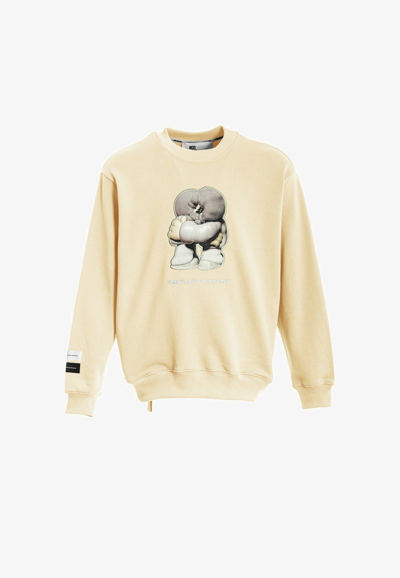 Sudadera beige con cuello redondo, que presenta un gráfico impreso de un personaje en el frente y una etiqueta de logo en la manga.