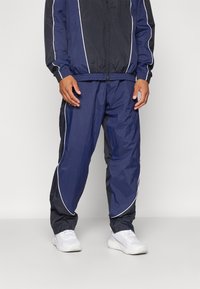 Under Armour - BEST TRACK PANT - Treningo apatinė dalis - black/midnight navy/white Miniatiūros vaizdas 1