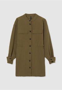 Longue veste boutonnée vert olive avec col montant, deux poches poitrine à rabat, deux poches inférieures à l'avant et poignets boutonnés.