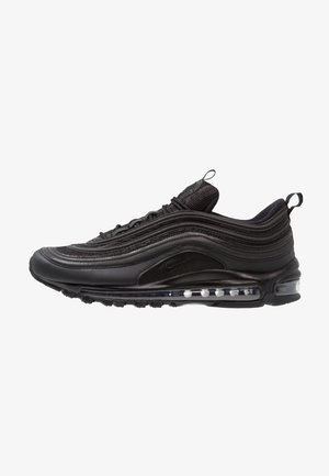 Zapatilla Nike Air Max 97 negra con líneas onduladas en la parte superior, suela con cojín de aire visible, lengüetas para tirar en la lengüeta y el talón, mostrada de perfil.
