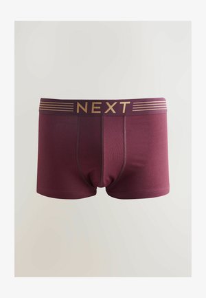 Caleçons boxers bordeaux avec un logo doré "NEXT" et des rayures horizontales sur la ceinture. Tissu lisse avec une coupe ajustée et sans motifs.