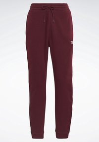 Bordeauxrote Reebok-Sweathose mit elastischem Bund, Kordelzug, gerippten Bündchen an den Knöcheln und kleinem weißen Logo am oberen linken Oberschenkel.