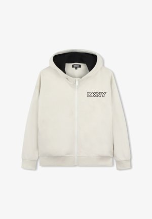 Haut à capuche zippé beige clair en tissu doux. Présente une doublure intérieure noire et un logo DKNY brodé sur la poitrine gauche. Manches longues.