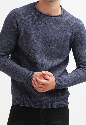 Navy blue knitted sweater with a round neckline, textured fabric, ribbed cuffs, and hem. Fitted design with raglan sleeves.