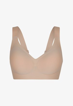 Soutien-gorge sans couture couleur peau avec larges bretelles réglables et bonnets moulés lisses pour un confort et un maintien optimal.