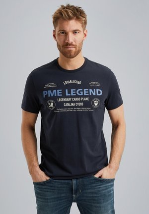 Navy blue cotton t-shirt featuring printed text and graphics in white and light blue, crew neck, short sleeves, casual fit, with a smooth texture.