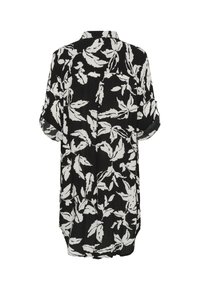 Robe-chemise noire à manches longues avec un motif abstrait de feuilles blanches, manches retroussées et détail d'empiècement au dos.