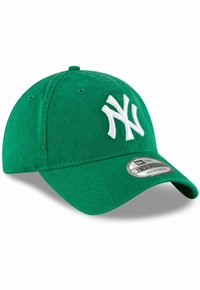 Grüner Baseballcap mit gebogenem Schirm, versehen mit einem weißen, gestickten 'NY'-Logo auf der Vorderseite und einem verstellbaren Riemen auf der Rückseite.