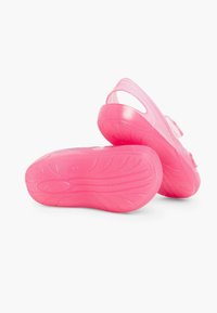 Pink plastic clogs with a textured sole, open heel, and adjustable straps. Lightweight design for comfort and ease of wear.