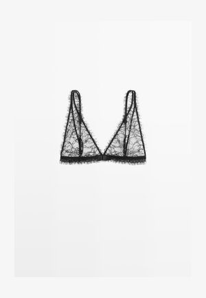 Bralette en dentelle noire avec une forme triangulaire, présentant un tissu transparent, des bords effilochés et des fines bretelles réglables. Pas de armature.