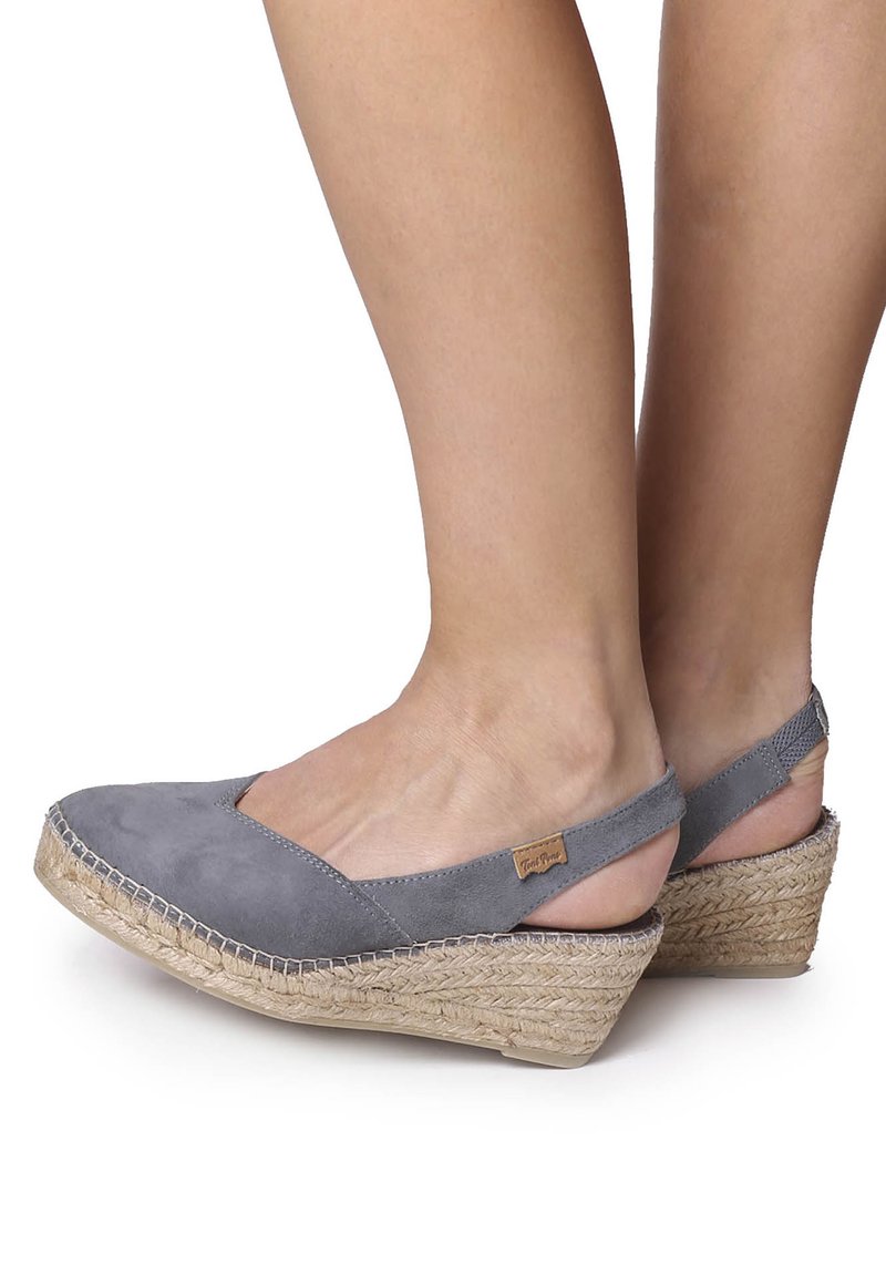 Gray suede wedge shoes with an open back, jute-wrapped heel, and a stitched detail along the sole. Sleek design with a comfortable fit.