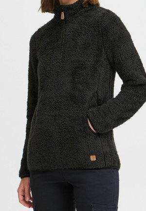 Zwarte fleece pullover met een hoge kraag, kwart rits en zijzakken. Beschikt over een gestructureerd, fluffy oppervlak en een klein logo-label.