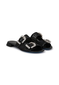 Black open-toe slide sandals with dual oval rhinestone buckles and textured fabric. Low heel, smooth sole, and blue accents on the underside.
