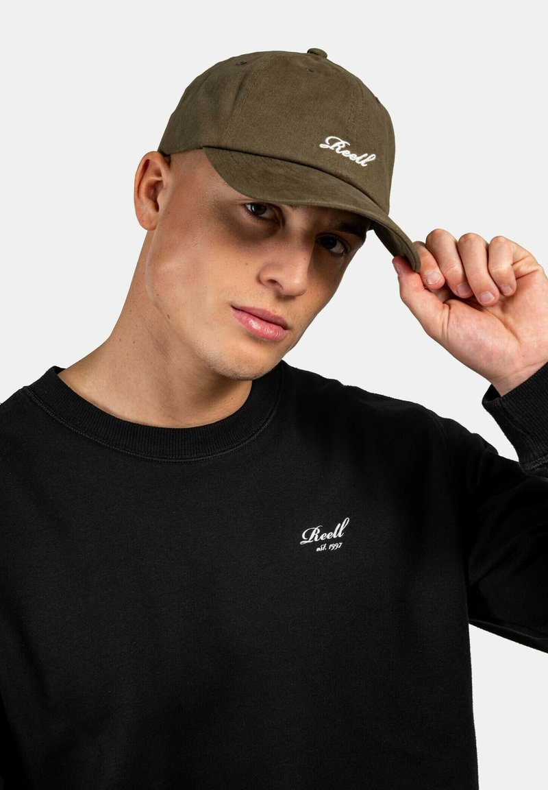 Olive green cap with a curved brim and white embroidered logo, paired with a black sweatshirt featuring a small white logo on the chest.
