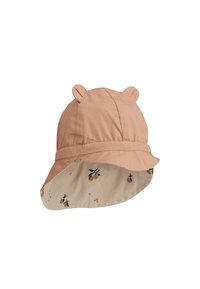 Persiku krāsas cepure-cepure ar lāča ausīm, iekšpusē gaišu puķu rakstu. Izgatavota no mīksta auduma ar plašu malām.