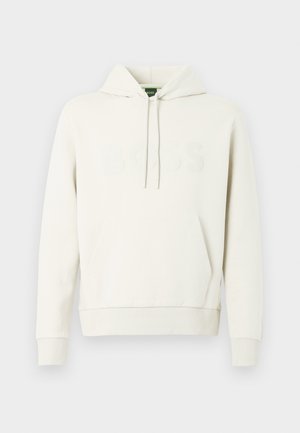 Cream-colored hoodie made of soft fabric, featuring a front kangaroo pocket, drawstring hood, and embossed "BOSS" logo on the chest.