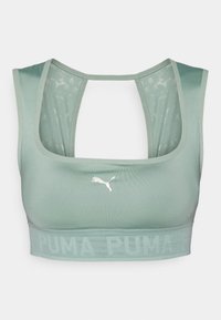 Šviesiai žalia sportinė liemenėlė su lygiu paviršiumi. Su plačia juosta ir "PUMA" logotipu bei lenkta nugarėlės forma.