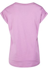 Short-sleeve t-shirt made of soft pink fabric. Round neckline, relaxed fit, and simple, unadorned design with a smooth texture.