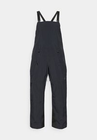 Μαύρος αδιάβροχος σαλβάρας με ρυθμιζόμενους ιμάντες, διαθέτει τσέπες με φερμουάρ και άνετη χαλαρή εφαρμογή, σχεδιασμένος για υπαίθριες δραστηριότητες.