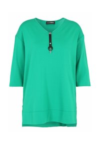 Green, short-sleeve top featuring a V-neck and a decorative zipper with a black strap and circular accent. Made from a soft, smooth material.