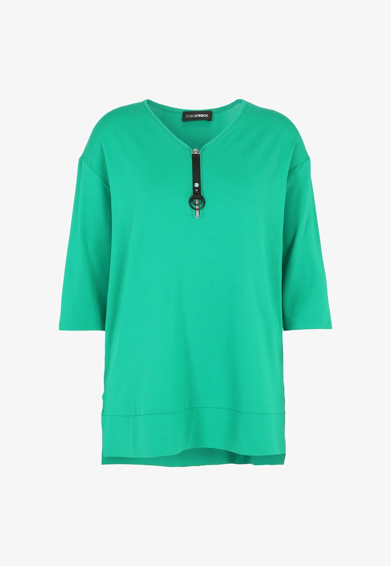 Green, short-sleeve top featuring a V-neck and a decorative zipper with a black strap and circular accent. Made from a soft, smooth material.