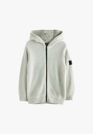 Hoodie en tricot côtelé gris clair avec une fermeture éclair à l'avant, des poches latérales et une étiquette en tissu noir sur la manche gauche. Texture douce, coupe décontractée.