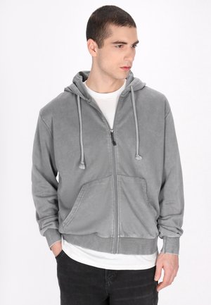 Grå zip-up hoodie med snor i hætten, kængurulommer og ribbede manchetter. Glat stof med en subtil tekstur og afslappet pasform.