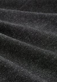 Black fabric with a textured surface, featuring fine gray specks. The material appears soft with visible folds and creases.