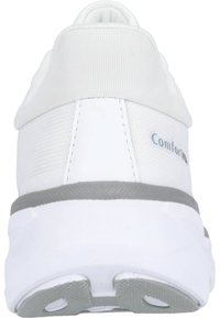 White athletic shoe with a textured upper, padded collar, and grey accents. Features a thick, cushioned sole with a patterned tread.