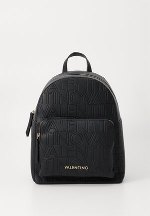 Black leather backpack with an embossed logo pattern, rounded top, front zip pocket, and gold-tone hardware accents. Subtle texture.