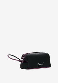 Black cosmetic bag with a rectangular shape, contrasting pink zipper, and handle. Features a smooth texture and subtle logo detail on the front.