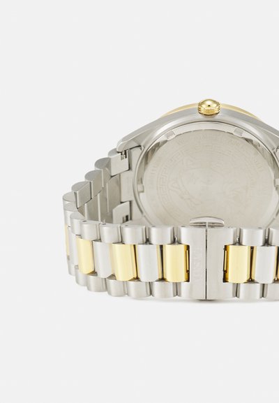 Kahes toonis roostevaba terasest kell, millel on hõbedane ja kuldne rihm. Ümmargusel korpusel on kuldne kroon ja graveeritud hõbedane tagakülg.