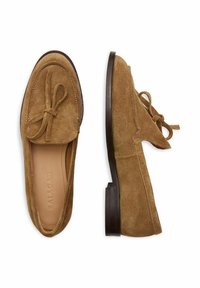 Semišové mokasíny světle hnědé barvy s mašlí na nártu, hnědou koženou stélkou a nízkým blokovým podpatkem. Na okrajích zdobeno prošitím.