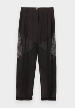 Pantalon noir transparent avec panneaux en dentelle sur les cuisses, poignets élastiqués, fermeture avant par boutons et taille plissée.