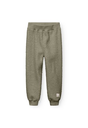 Long, loose-fitting joggers made of soft, textured green fleece with a ribbed waistband and cuffs. Features a small brand tag on the side.